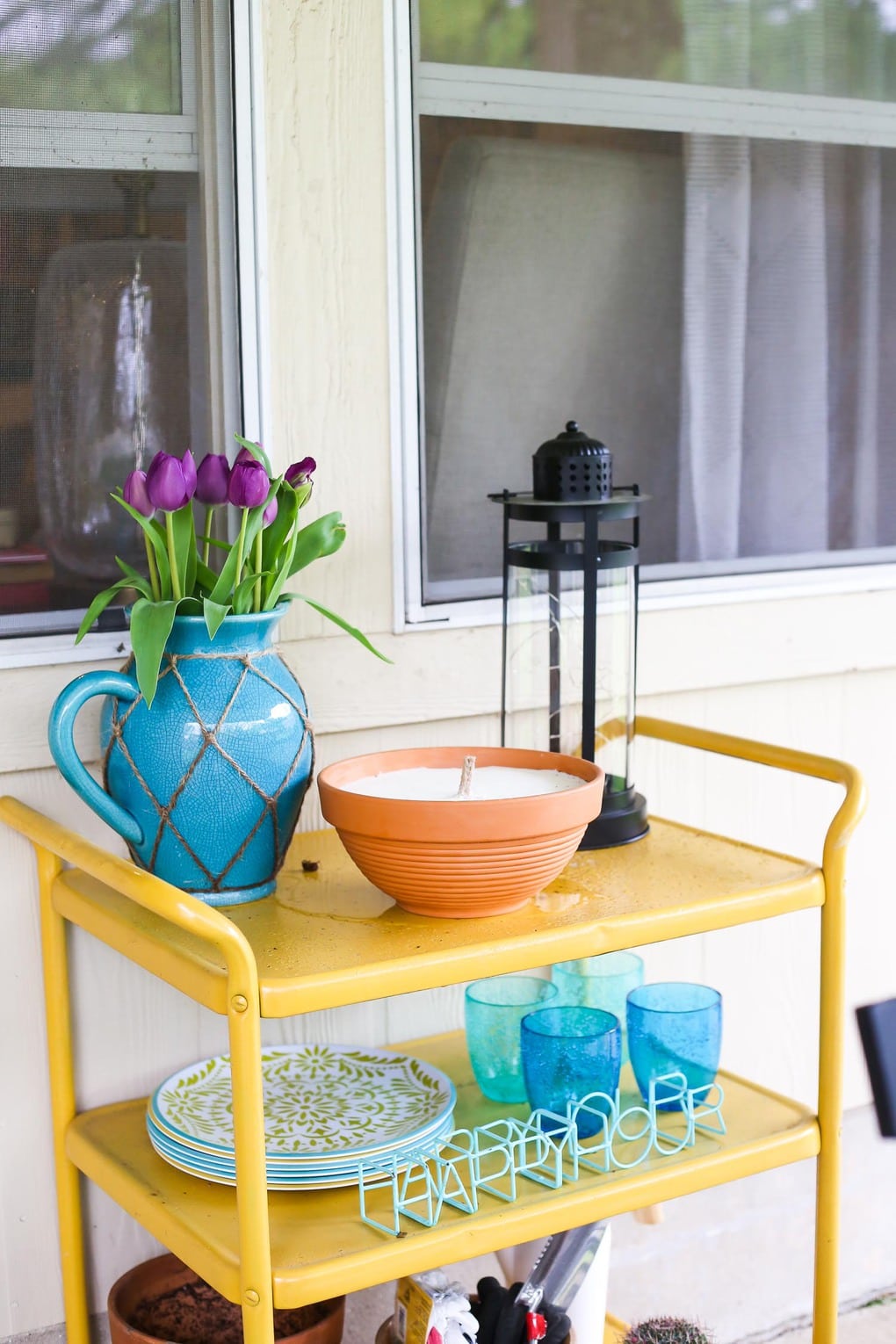 Yellow backyard bar cart with blue decor