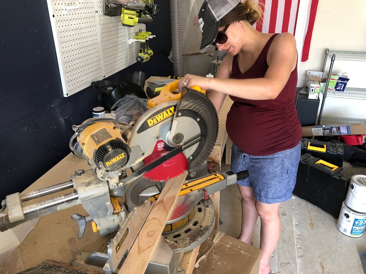 using miter saw to cut wood for outdoor art
