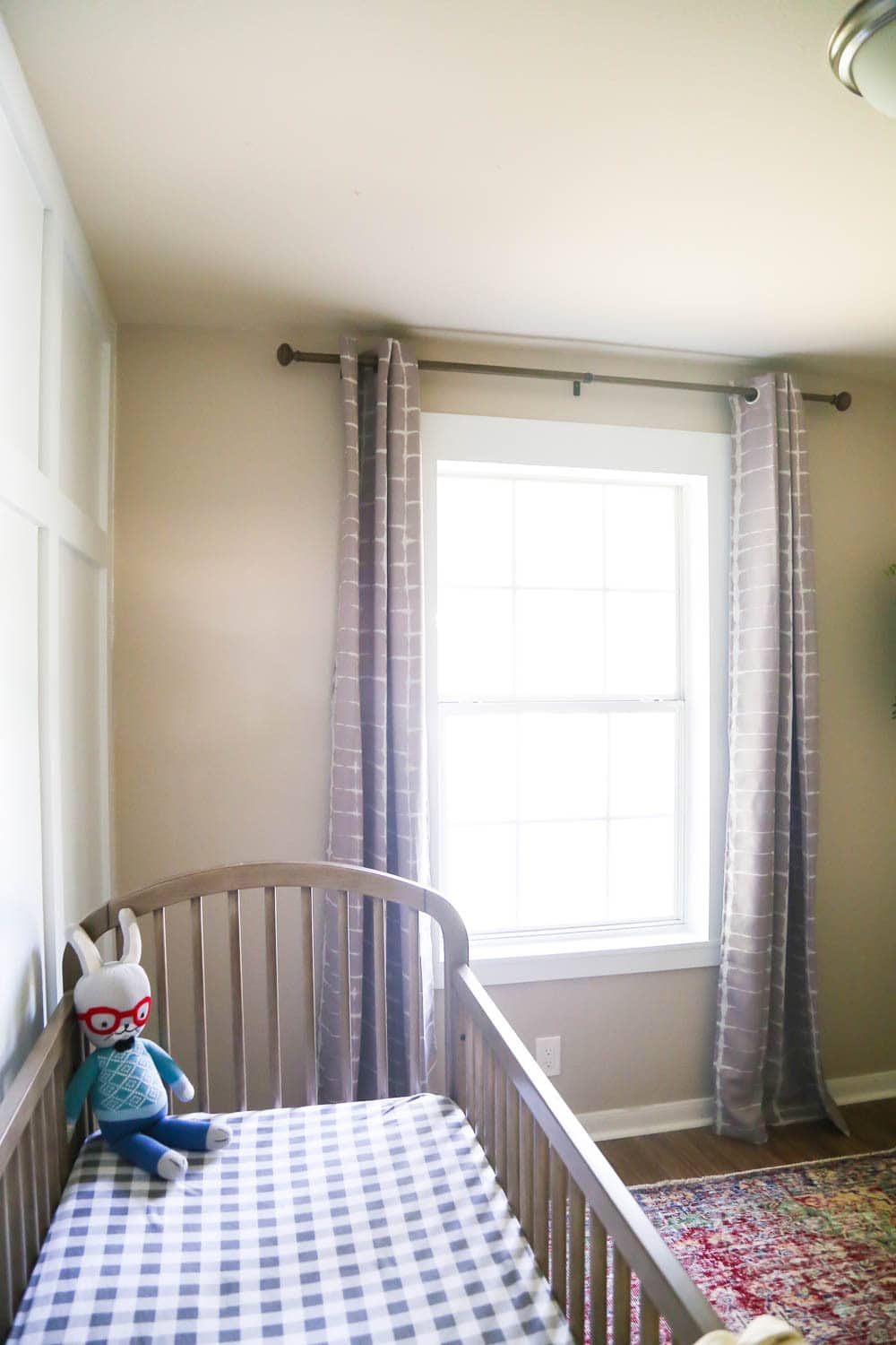 a room with curtains and DIY window trim on the window 