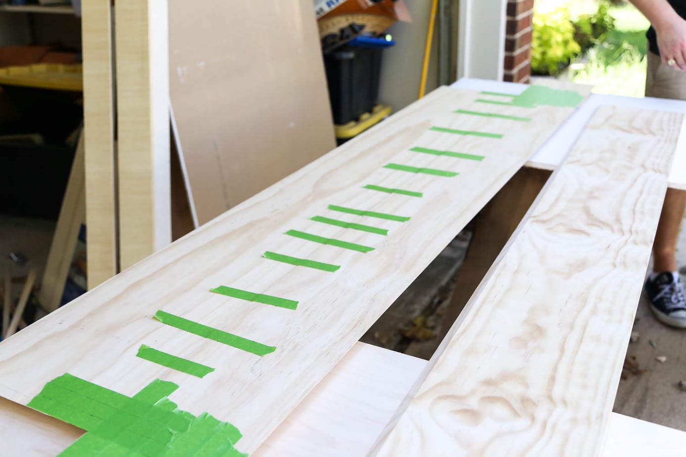 pine boards taped together for a diy fireplace mantel