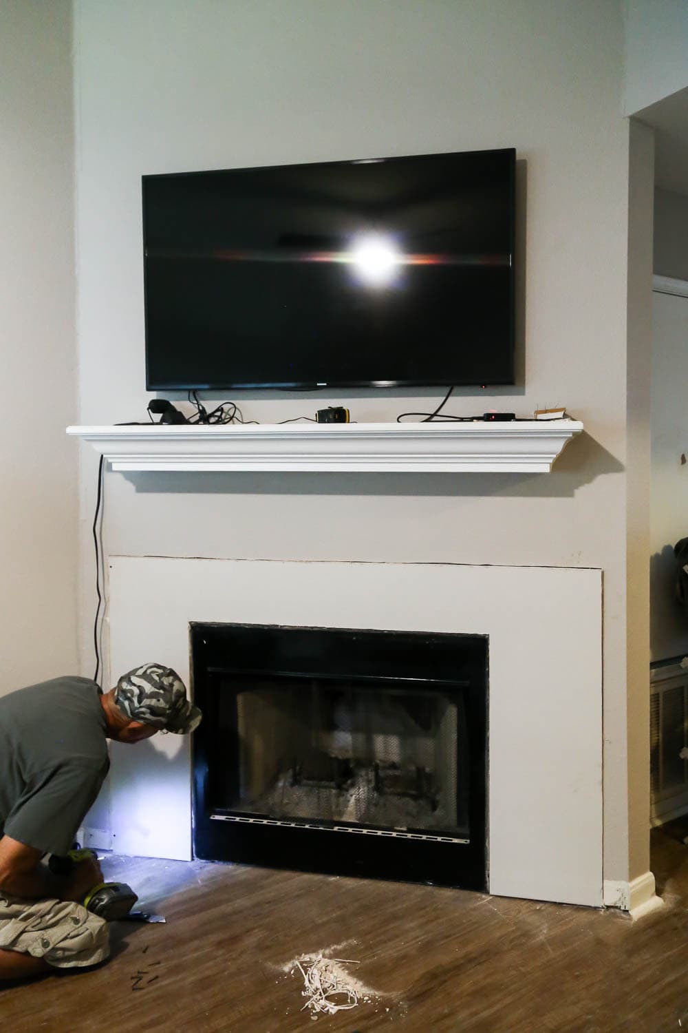 an angled fireplace wall with fresh drywall