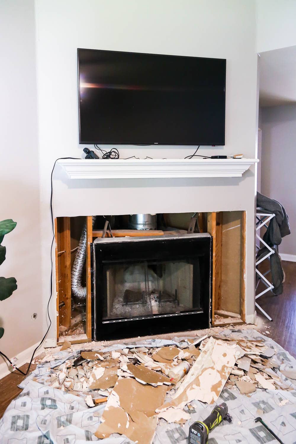 a fireplace wall with drywall removed