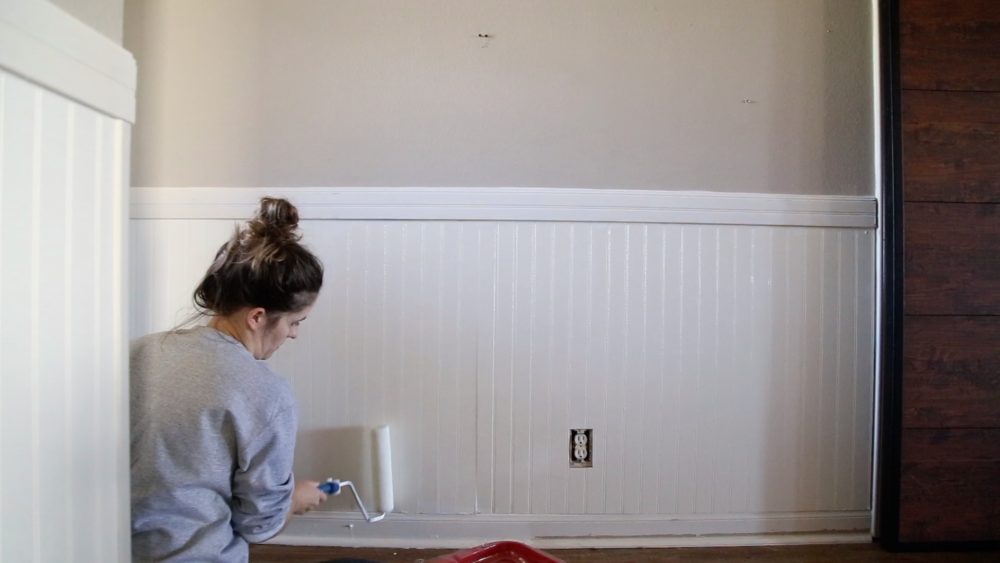 woman painting beadboard paneling