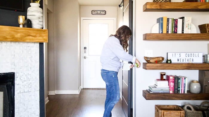 woman measuring wall to install beadboard paneling