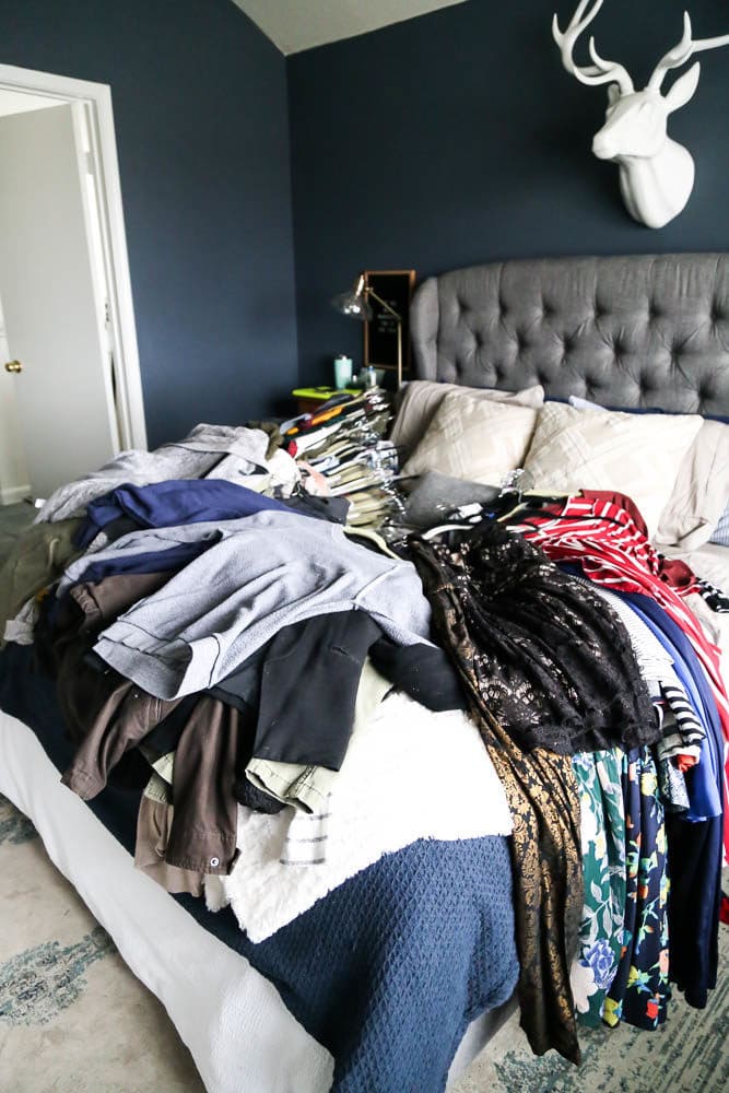 clothes laying on bed - ready to be organized