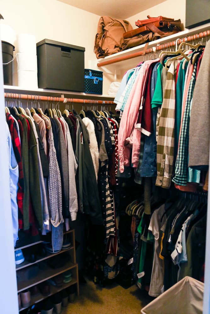 closet with clothing hanging on racks