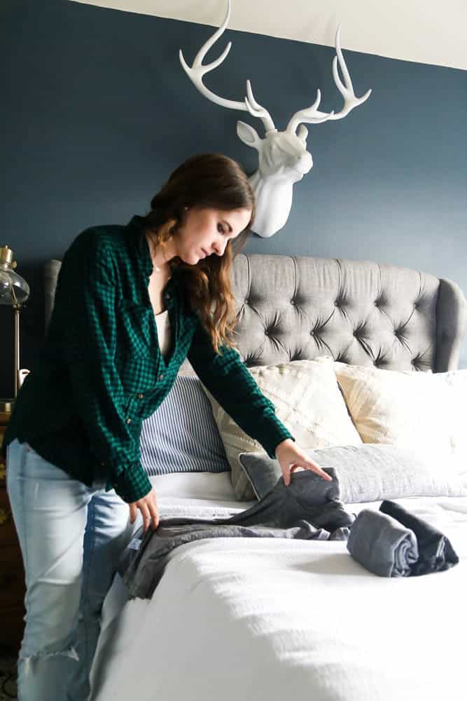 woman folding clothing using the konmari method