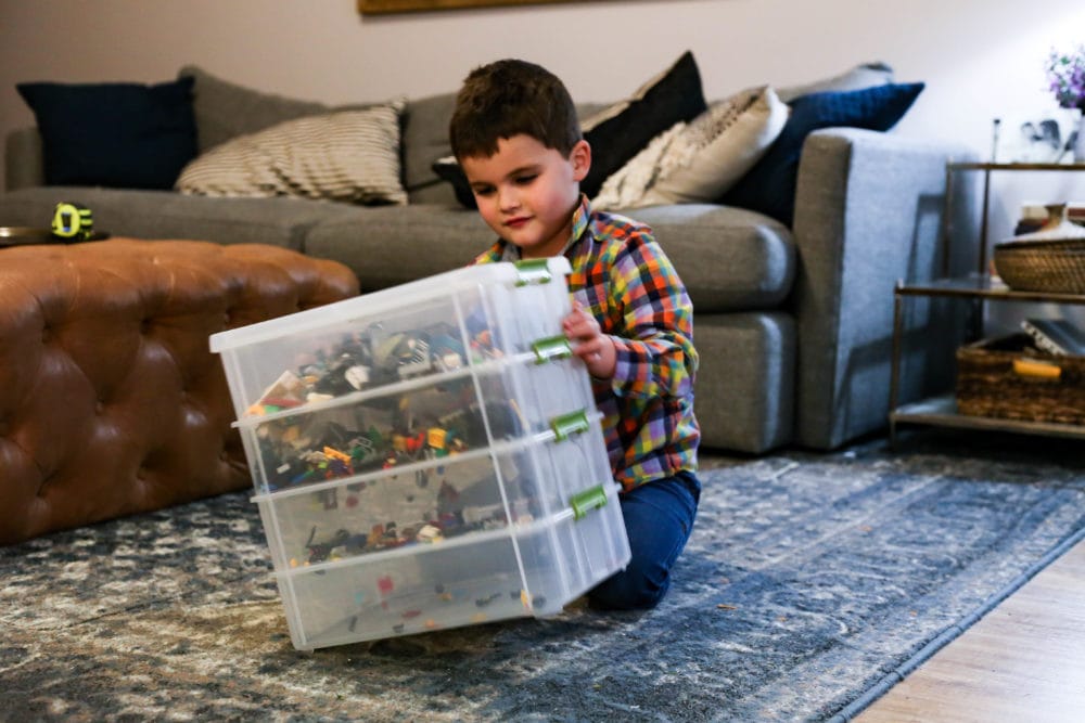 boy organizing LEGO bricks with DIY organizer