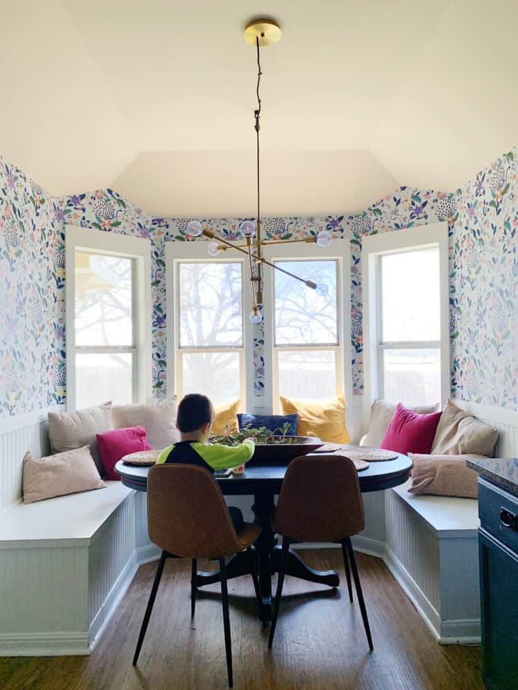 young boy sitting at a dining room table 