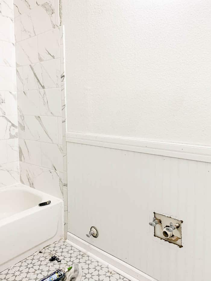 bathroom with beadboard paneling installed on lower half of walls