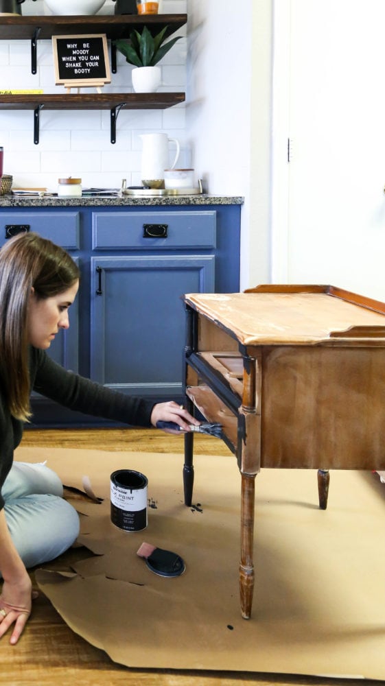 woman painting a small side table using Rustoleum Milk Paint Finish