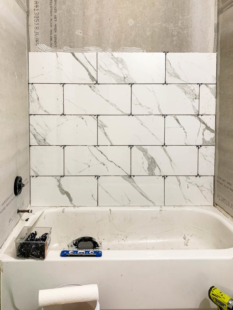 bathtub surround being tiled