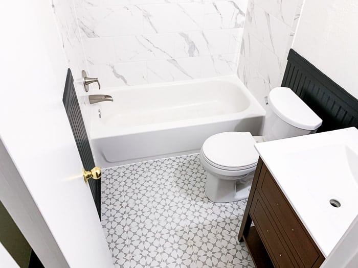 black and white bathroom with black beadboard walls