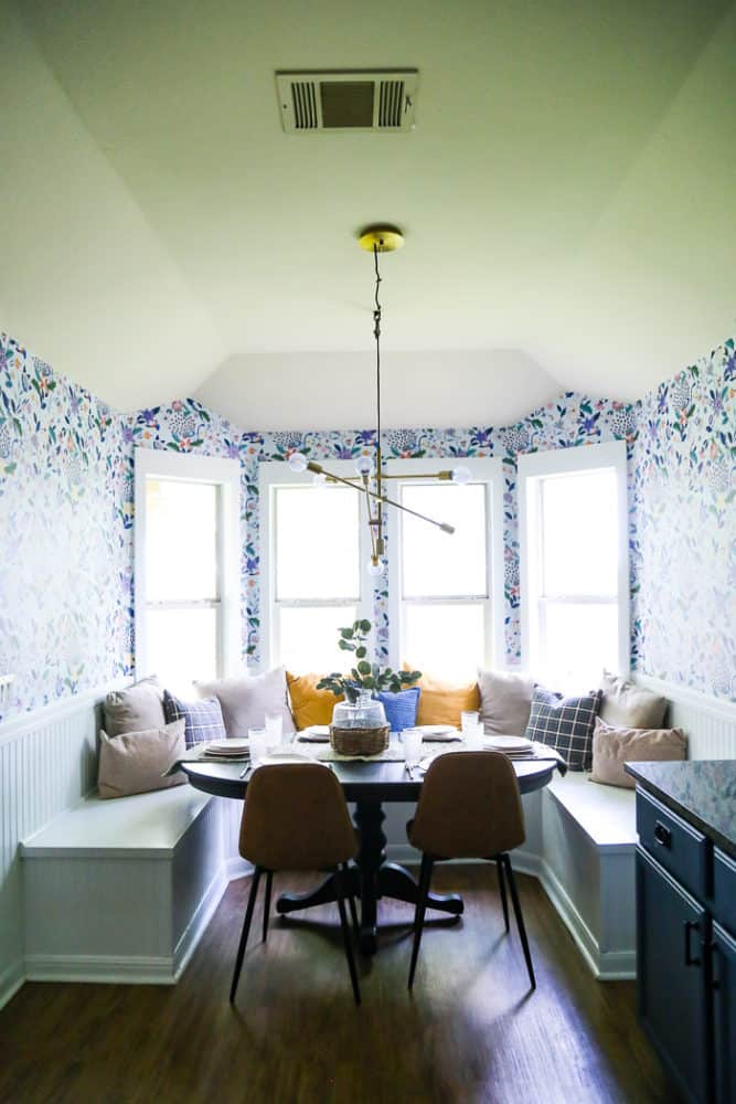 Dining room with built in banquette seating and floral wallpaper