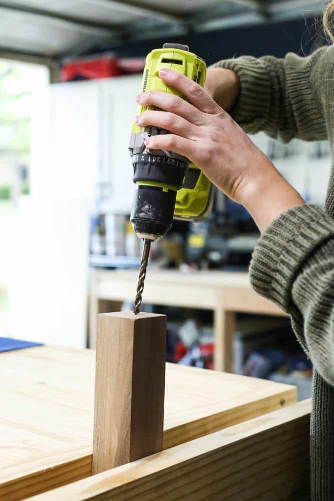 woman using a vice to drill 