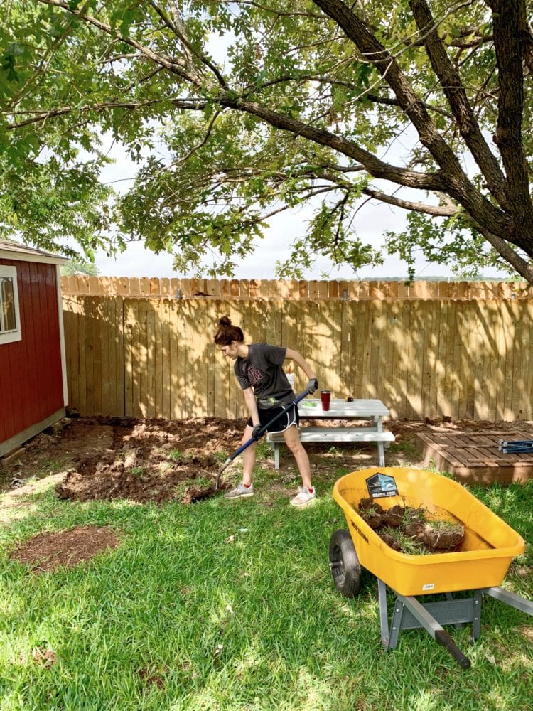 woman digging in a backyard