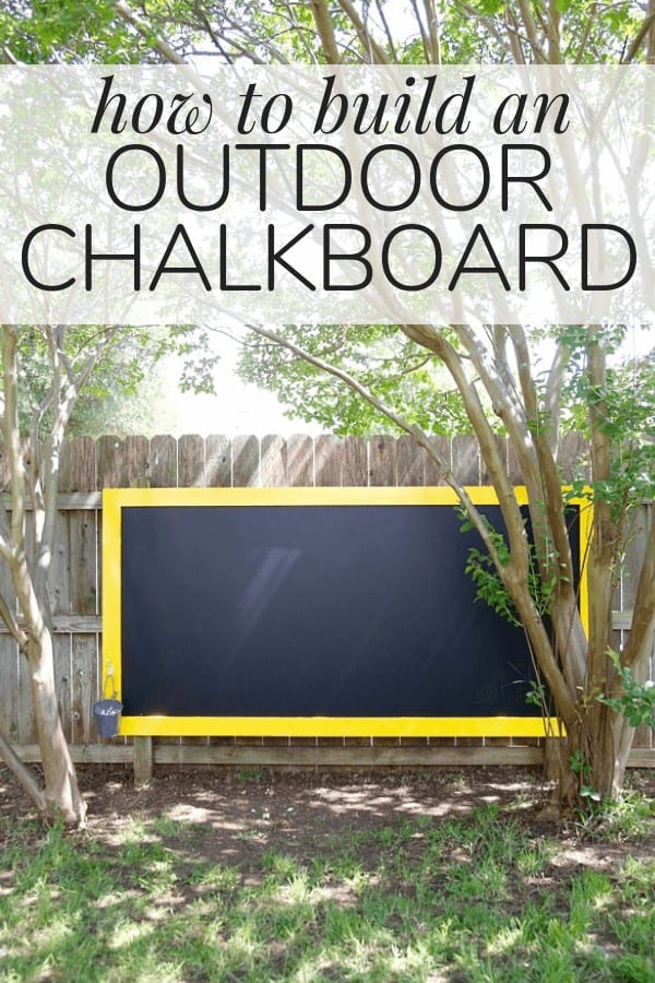 Large chalkboard hanging on a fence with text overlay - "how to build an outdoor chalkboard"