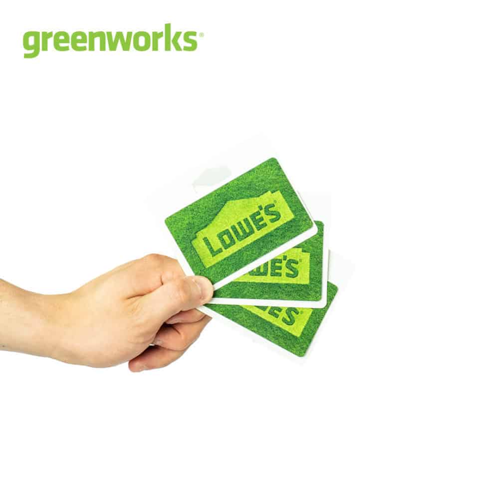 image of a hand holding Lowe's gift cards with Greenworks logo