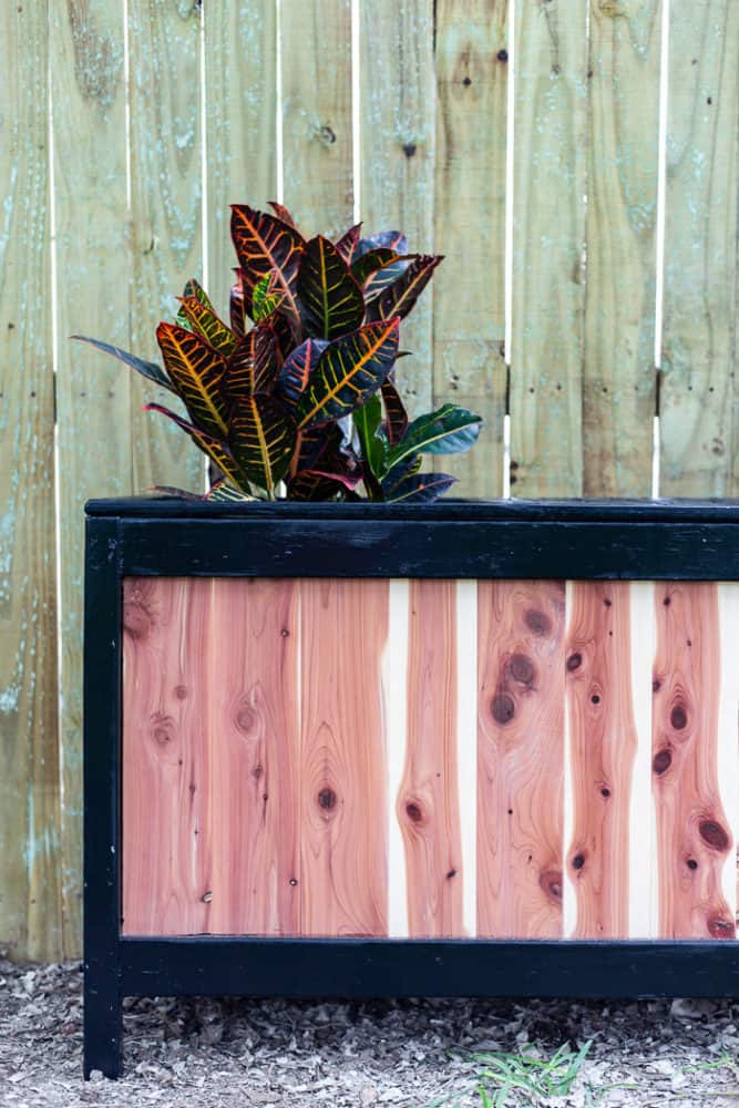 close up of a cedar planter with a bench built in