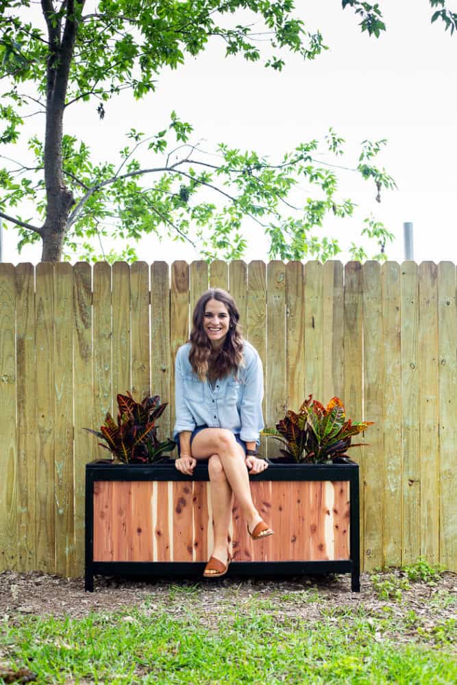 planter bench with a woman sitting on it