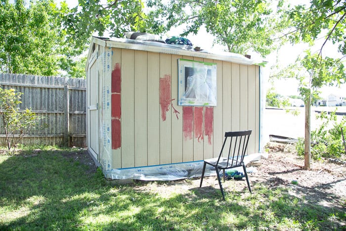 outdoor shed taped off to be painted