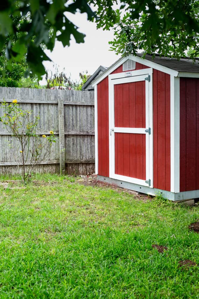 A backyard shed that has been painted red