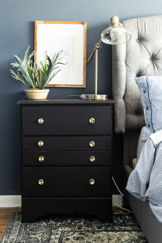 Black dresser used as a nightstand