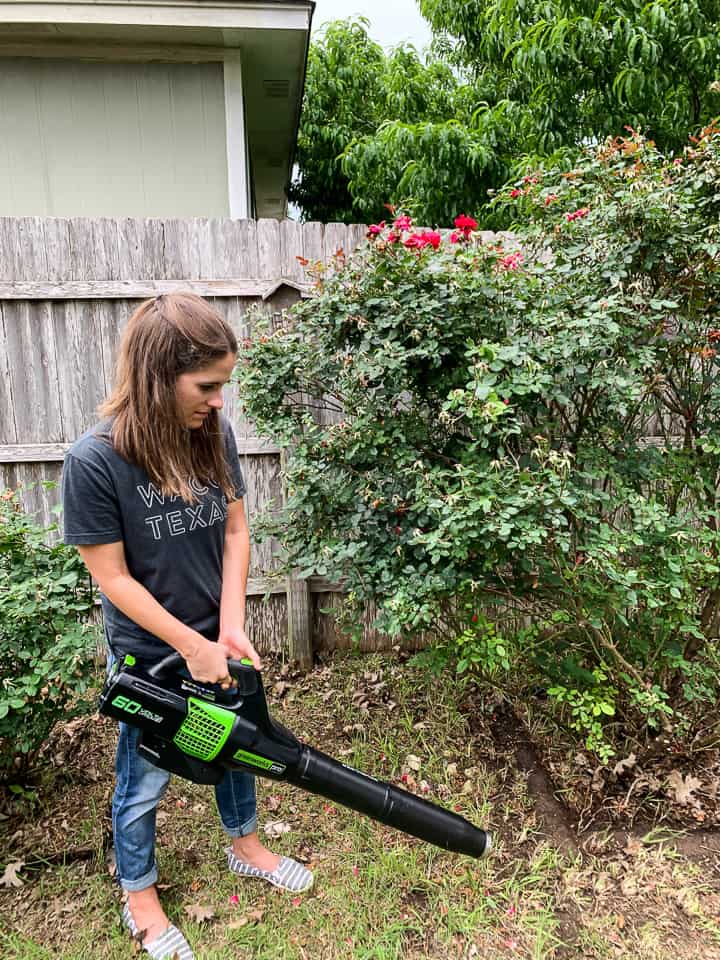 woman using a greenworks leaf blower