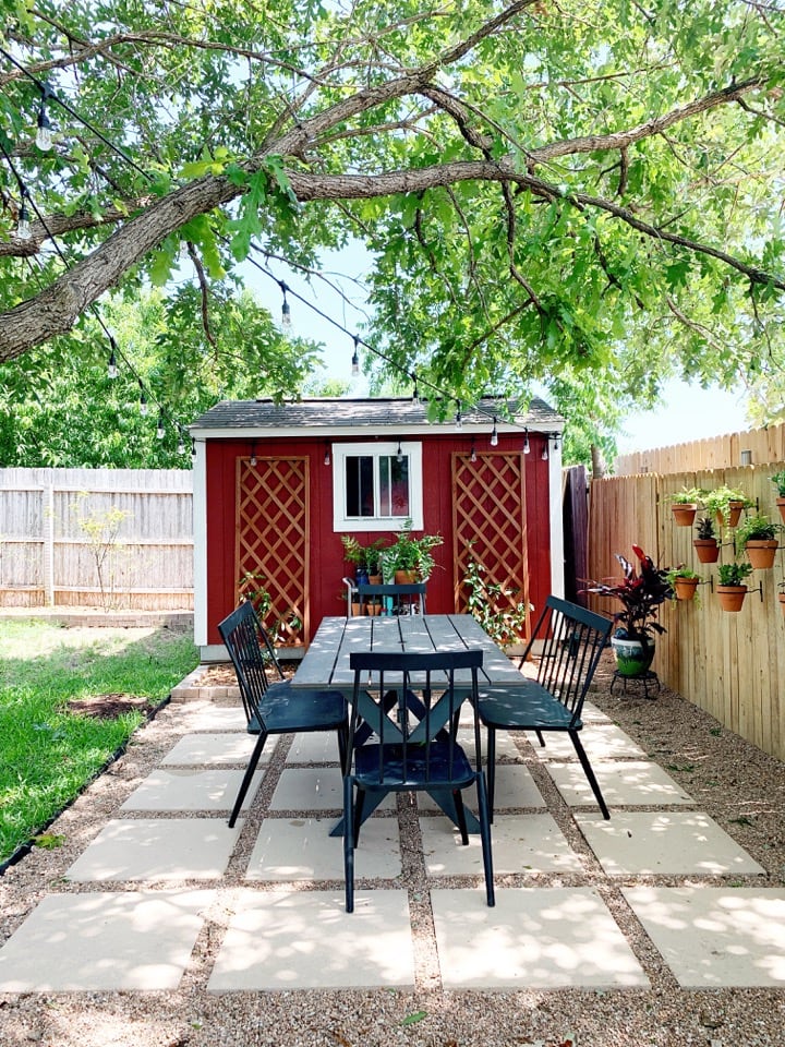 pea gravel and paver patio with red storage shed