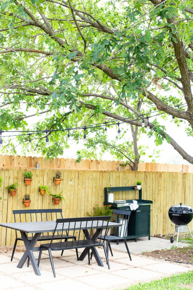 pea gravel and paver patio with a grill area 