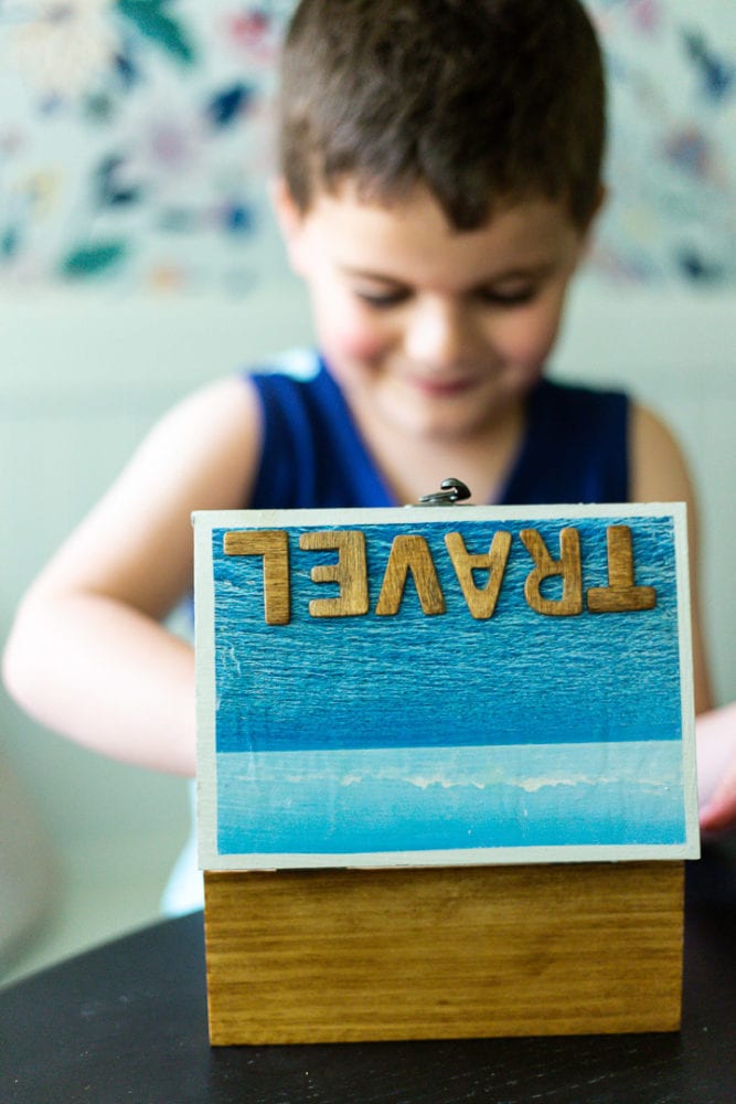 boy looking inside a DIY travel memory box