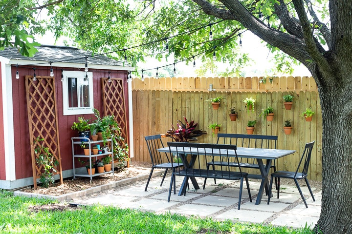 styled pea gravel patio in a lush backyard