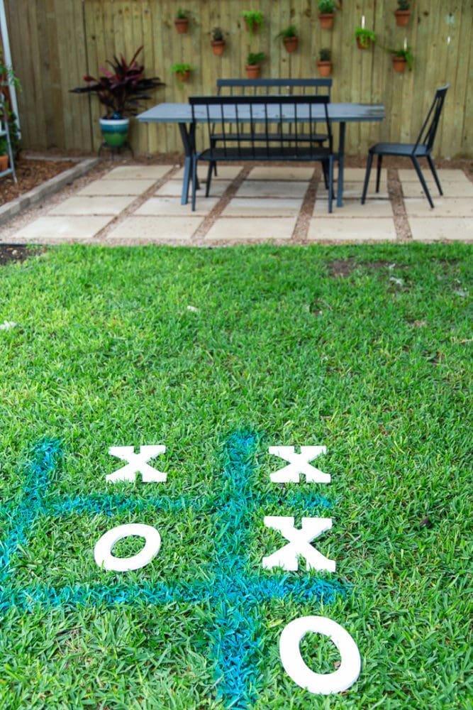 tic tac toe board drawn with spray chalk in the grass