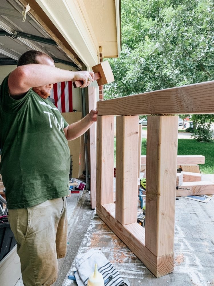 man assembling a DIY outdoor sofa