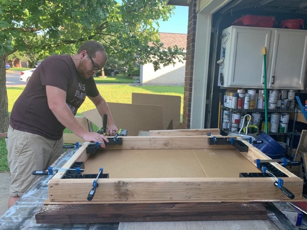 man assembling a table top