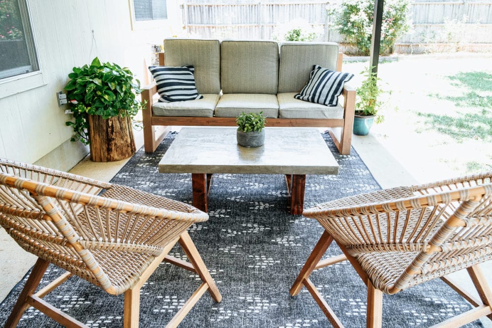 back porch with DIY outdoor sofa, a DIY coffee table, and two lounge chairs