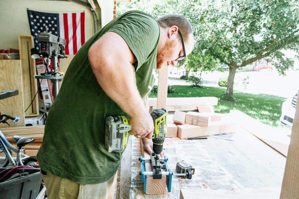 man drilling holes for a joinery system