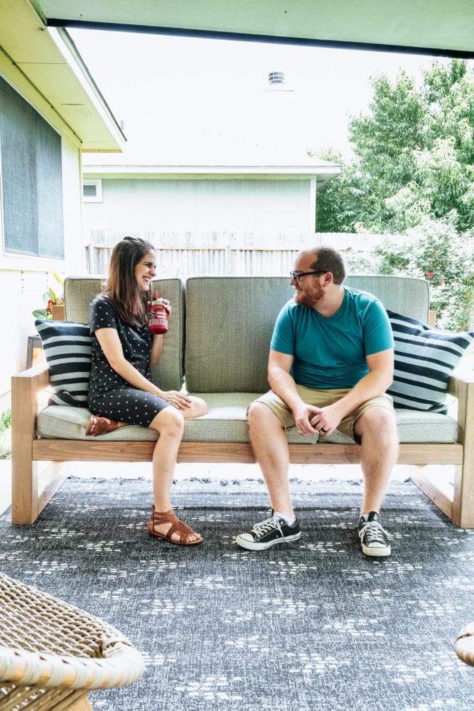 man and woman talking on a DIY outdoor sofa