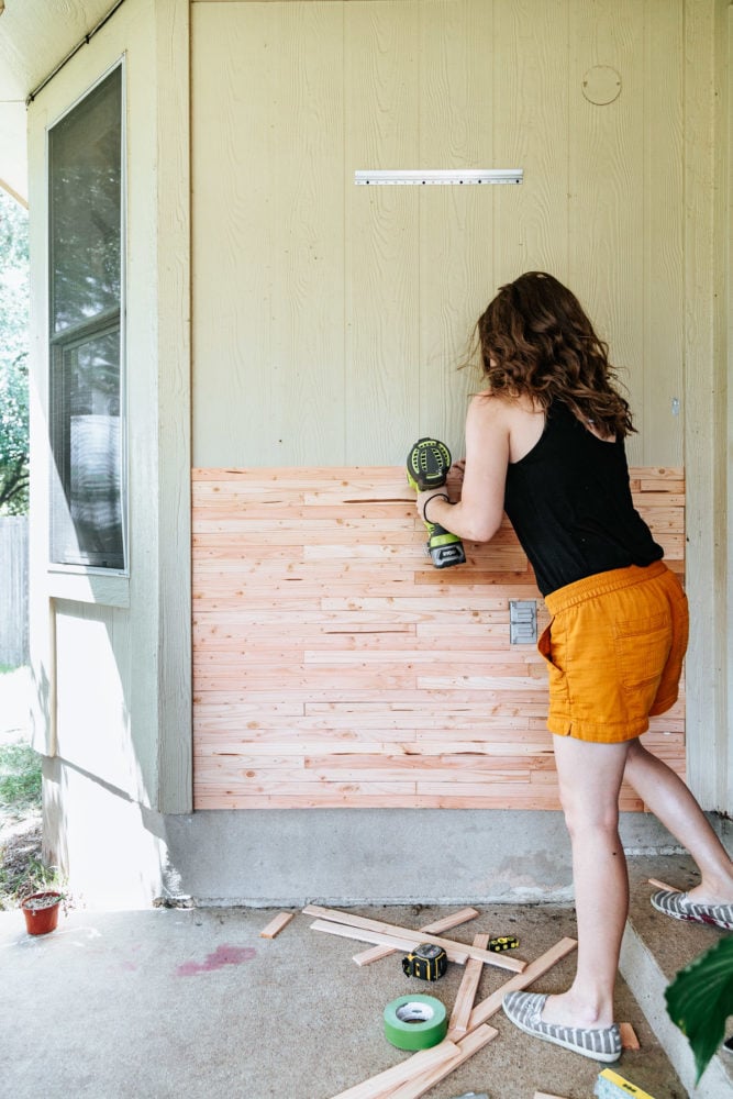 woman installing lath board for skinny lap wall 