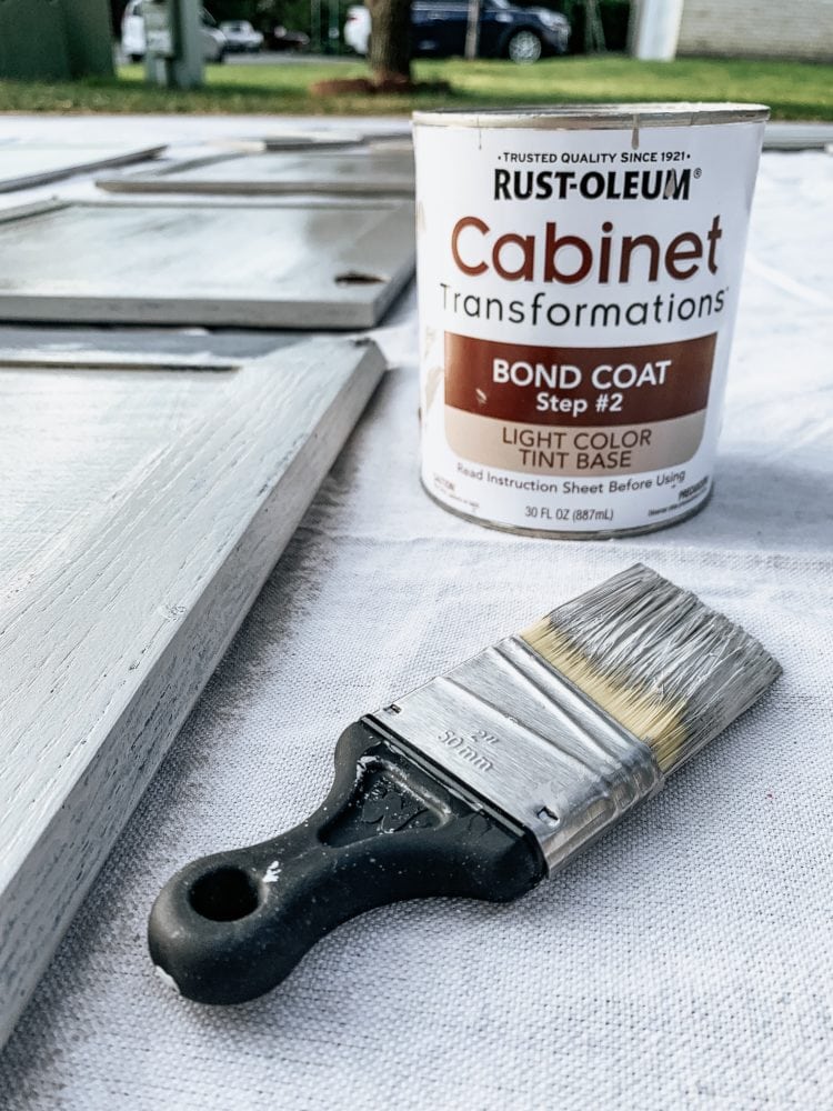 close up of cabinet transformations can with a wet paint brush