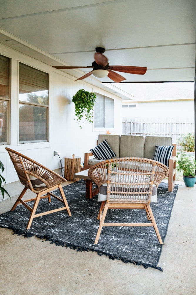 back patio with a couch and two lounge chairs