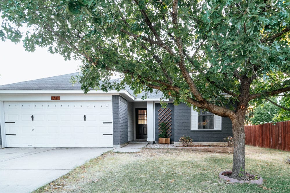 brick house painted with Romabio Navy steel and white siding