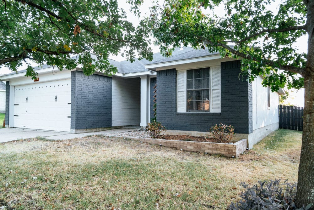 after of blue painted brick house