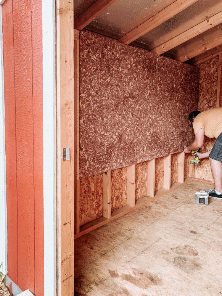 man installing cedar flakeboard panels