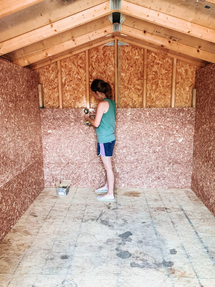 woman installing cedar flakeboard panels