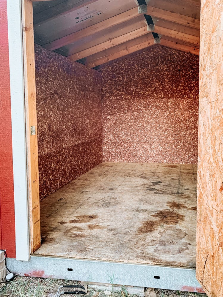 shed walls with cedar flakeboard panels installed