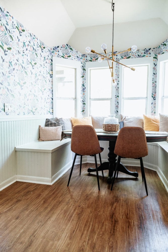 bright, colorful dining room nook with a DIY bay window bench