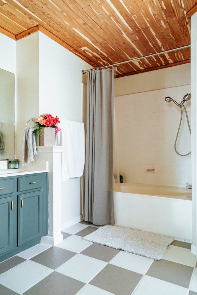 finished bathroom with painted tile floor 