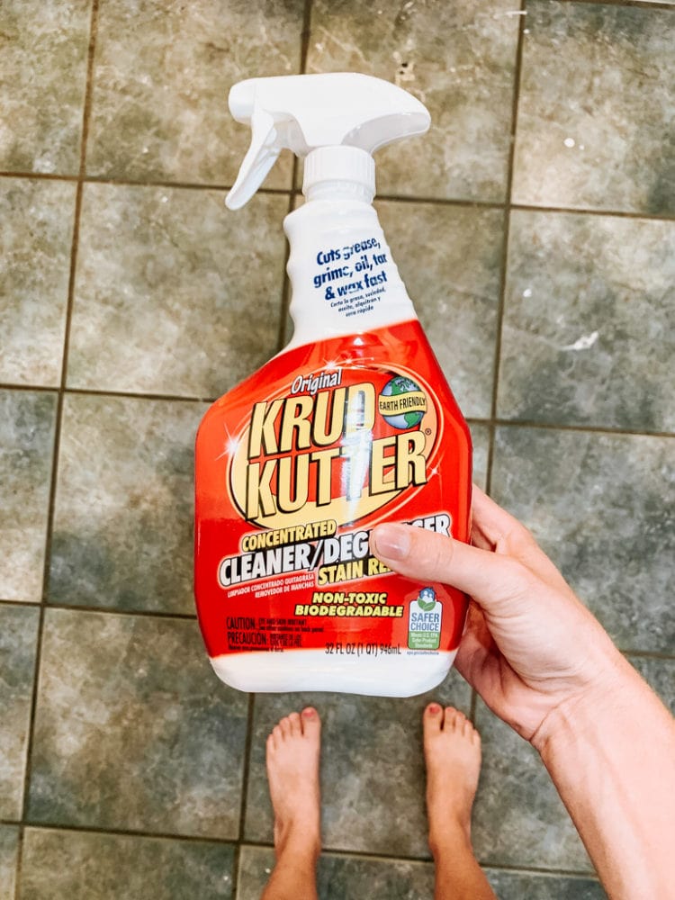 woman's hand holding a spray bottle of Krud Kutter