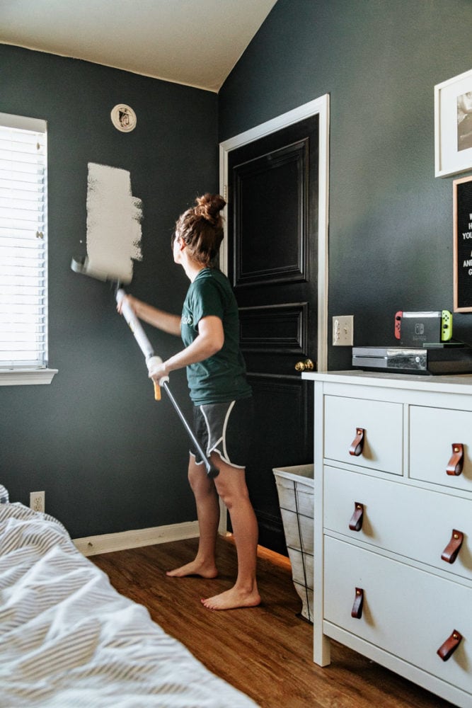 woman painting a room using a smart roller